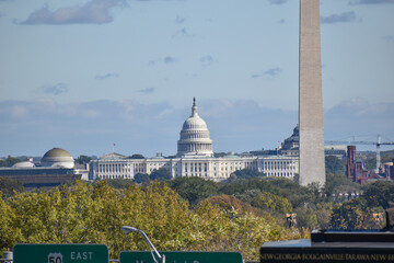 Washington, DC, USA - October 27, 2021: U.S. Capitol Building, Framed by Trees in the Foreground, as Seen from a Hill in Arlington Ridge Park on a Clear Fall Afternoon