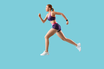 Fototapeta na wymiar Sporty running woman on color background