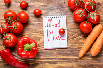 Meal plan with fresh vegetables on wooden background