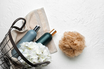 Basket of bath supplies on light background