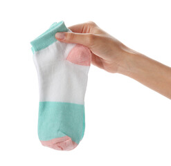 Woman holding pair of socks on white background, closeup