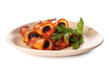 Plate with prunes in crispy bacon and parsley on white background