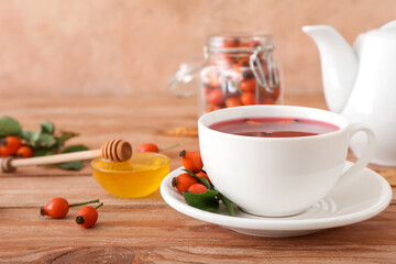 Cup of rose hip tea on table