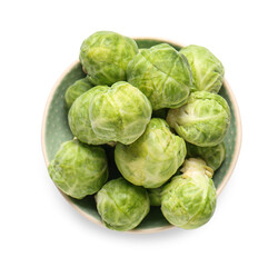 Bowl with fresh raw Brussels cabbage on white background