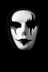 Scary mask for Halloween  with dramatic lighting and black background © Philip