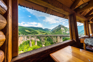 View of Tara Canyon Bridge through log cabin window,Durmitor National Park,Montenegro.