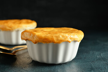 Tasty vegetable pot pies on black background