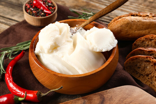 Bowl of lard spread on wooden background