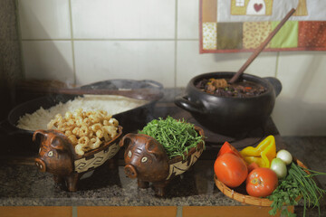 Cooking feijoada on a wood stove