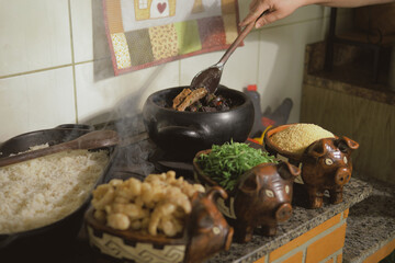 Cooking feijoada on a wood stove