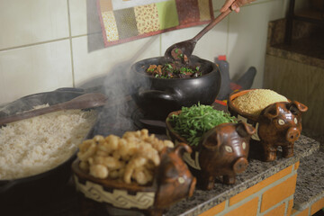 Cooking feijoada on a wood stove