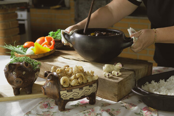 Serving feijoada, a Brazilian dish on a lunch table