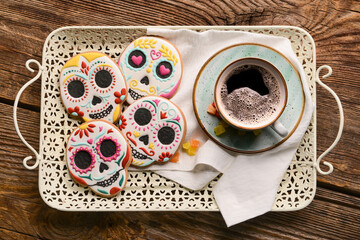 Tray with cookies for Mexico's Day of the Dead (El Dia de Muertos) and cup of coffee on wooden background