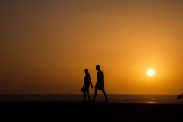 Fototapeta na wymiar Evening walk by the sea in sunset