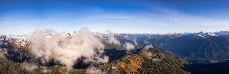 Aerial Panoramic View of Canadian Rocky Mountains with snow on top during Fall Season. Nature Landscape located near Chilliwack, East of Vancouver, British Columbia, Canada. Nature Background Panorama