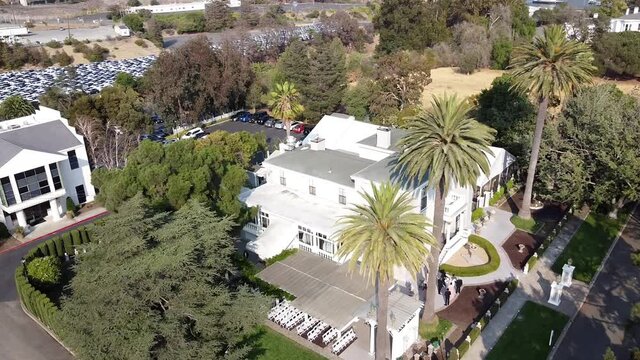 Panoramic view from above of a white stylish villa, typical for weddings, and places around. St. Benicia, California. Slow motion