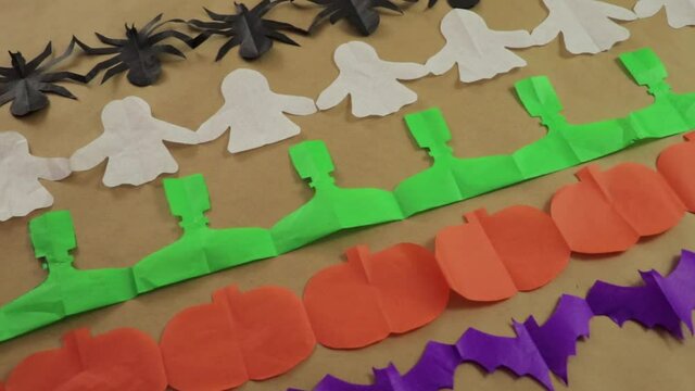 Halloween tisue paper garlands. Spider, ghost, frankesntein and pumkin. Decorations and ornaments. Panning.
