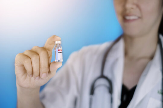 A doctor in white coat and stethoscope around her neck is holding a glass bottle of BCG vaccine which prevent tuberculosis, a kind of bacterial infection.  Healthcare And Medical concept.