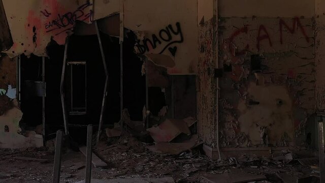 slow movement into a dark room of an abandoned sanitorium