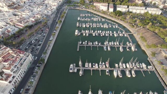 Boats dock at Port Ayamonte, Spain, Estero de la Rivera, drone flyover