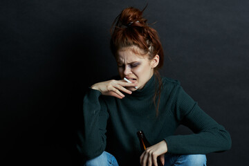 woman with bottle of alcohol smokes a cigarette depression bruises under eyes emotions