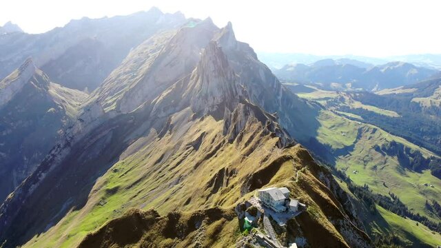 Aerial flyover over Schaefler ridge in Appenzell, Switzerland with view of Alpstein peaks in daylight