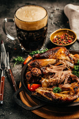 Roasted pork knuckle with sauerkraut and beer. Oktoberfest menu. Traditional dish in German cuisine schweinshaxe