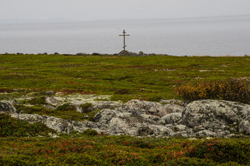 Fototapeta na wymiar Wooden worship cross on the shore of the White Sea. Russia, Solovki 