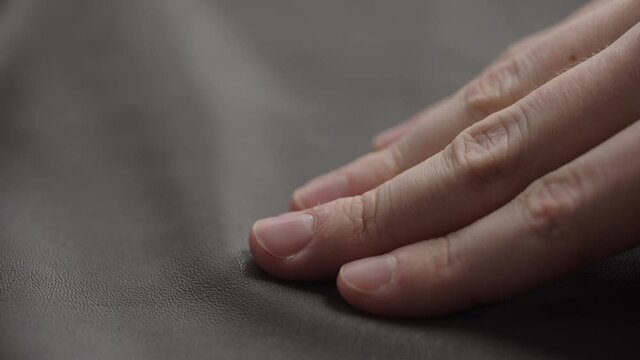 Slide shot man touching fine leather closeup