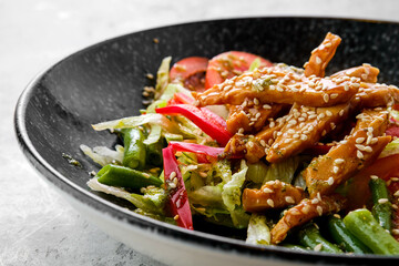 Closeup view of salad with chicken and teriyaki sauce