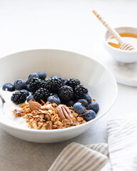 Breakfast, Granola with yogurt and berries on a concrete background