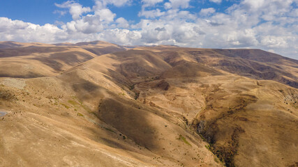 Fototapeta na wymiar Autumn Landscape of Hills with Golden Dried Grass in Armenia, Aerial View