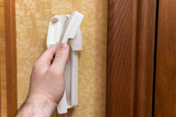 man answers the call to the intercom, close-up of the intercom