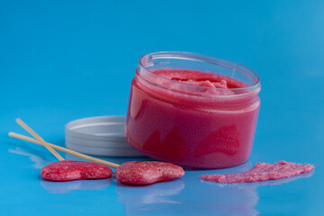 Sugar body scrub on blue background