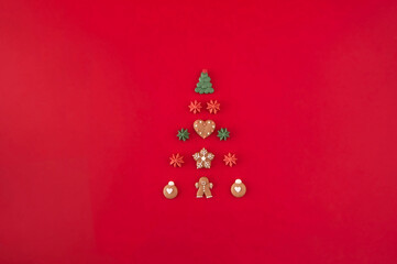 Naklejka na ściany i meble Christmas tree of cookies on the red background. Christmas holiday creative concept.