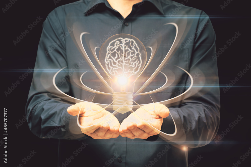Aufkleber close up of male hand holding abstract light bulb on dark wide background with digital brain and ato