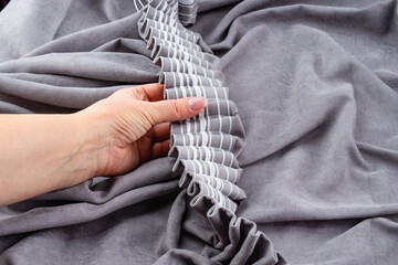 Close up of woman hands hanging curtain