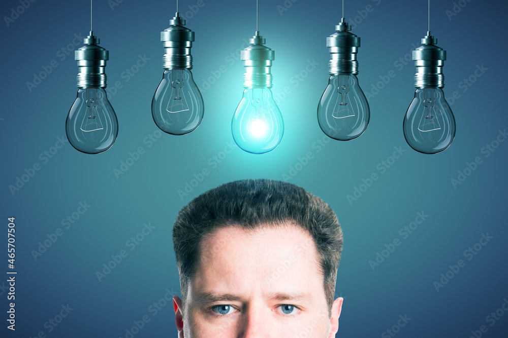 Aufkleber half portrait of young european businessman with abstract glowing row of light bulbs on red backgrou