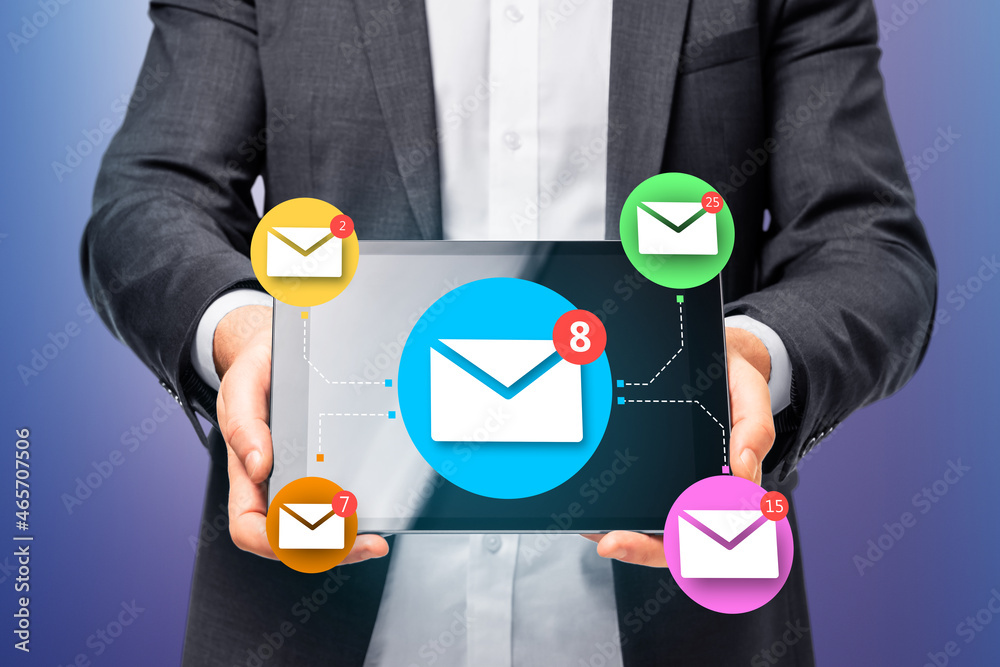 Poster Close up of businessman hand holding digital tablet with abstract email network on blue wall background. Social networking and communication concept.