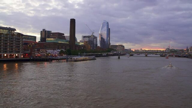 London sunset on the River Thames with the architecture of the Tate Modern art gallery, One Blackfriars skyscraper and the Millenium Bridge
