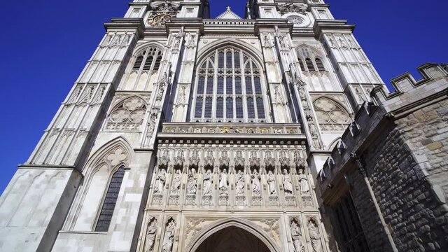 Tilting shot revealing the impressive gothic west front of Westminster abbey in London, England