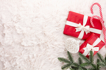 Christmas composition. Gift box, christmas decorations on wool background. Flat lay, top view, copy space.
