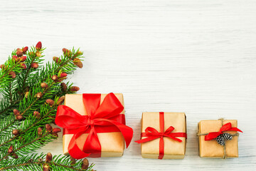 New Year's composition of spruce paws and gifts on a light background, Christmas decoration