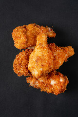 fried chicken on the black background