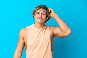 Naklejka premium Handsome blonde man isolated on blue background with an expression of frustration and not understanding