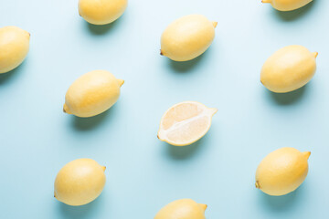 Several yellow bright lemons on a colored background. Bright citruses.