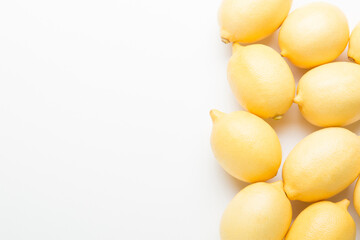 Several yellow bright lemons on a white background. Bright citruses.