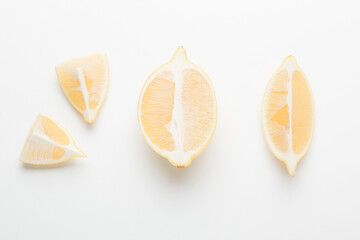 Several yellow bright lemons on a white background. Bright citruses in a cut.