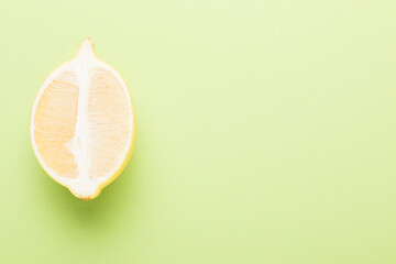 Several yellow bright lemons on a colored background. Bright citruses in a cut.