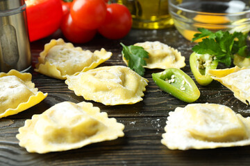 Concept of cooking ravioli on wooden background